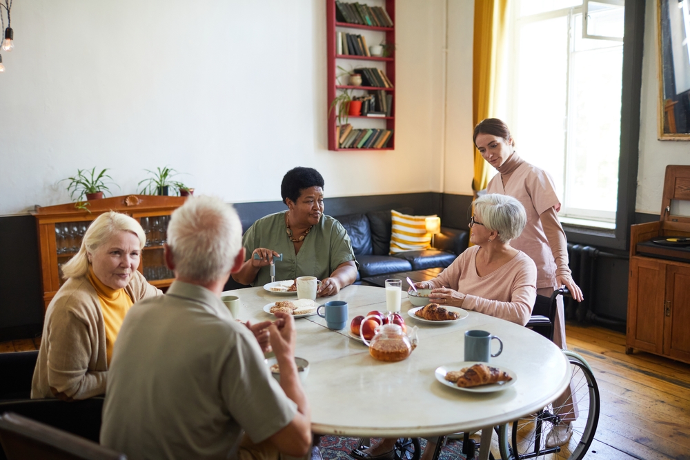 Group of seniors having breakfast in a cozy residence